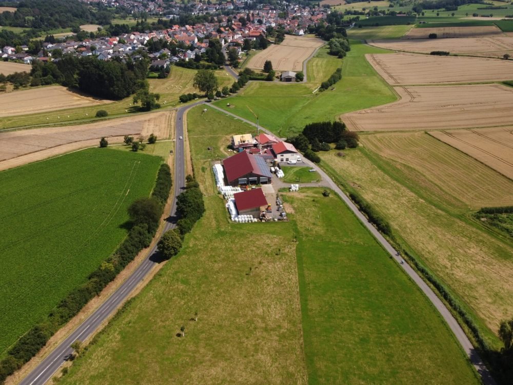 An aerial view of a village with fields around it