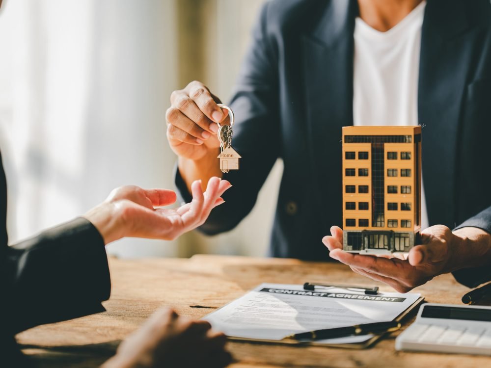 real estate agent Delivering keys and model homes to customers and home insurance contracts; home mortgage loan concepts